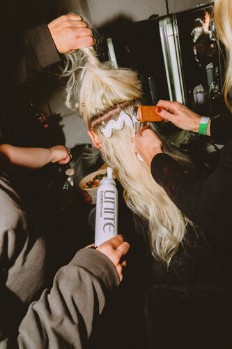 Backstage hair preparation using UNITE Elevate Mousse for runway styling at London Fashion Week with Sally Beauty.